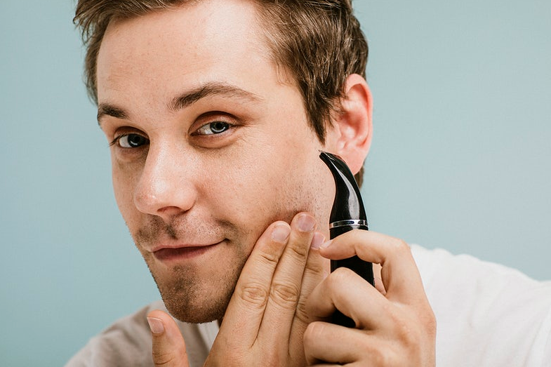 man shaving beard